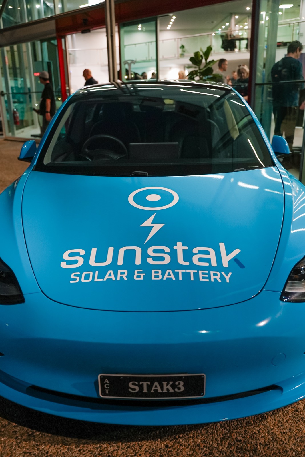 The Sunstak logo on the bonnet of a blue Tesla