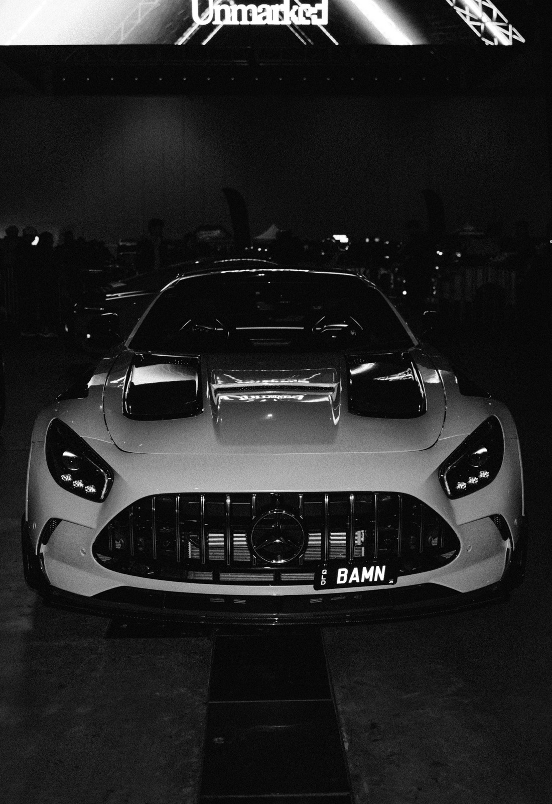 A white Mercedes-AMG under the Unmarked sign